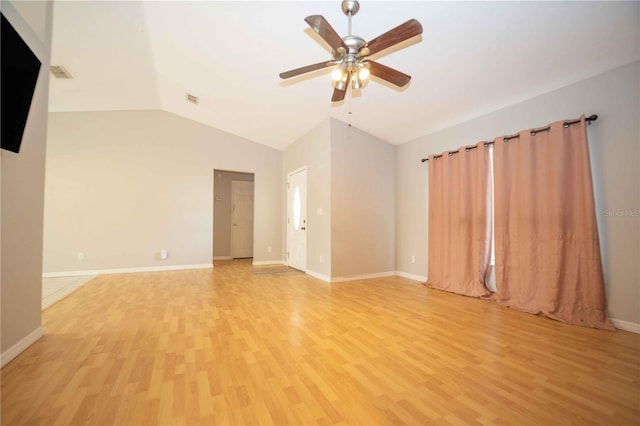 spare room featuring light wood-type flooring, ceiling fan, and vaulted ceiling