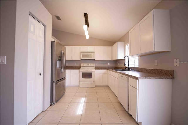 kitchen with white cabinetry, sink, white appliances, and vaulted ceiling