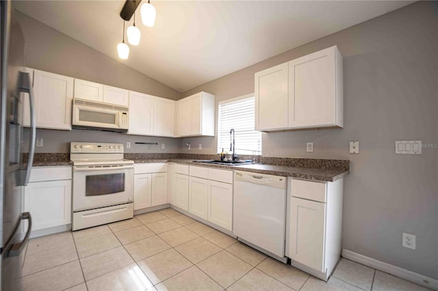 kitchen with white appliances, white cabinetry, sink, and vaulted ceiling