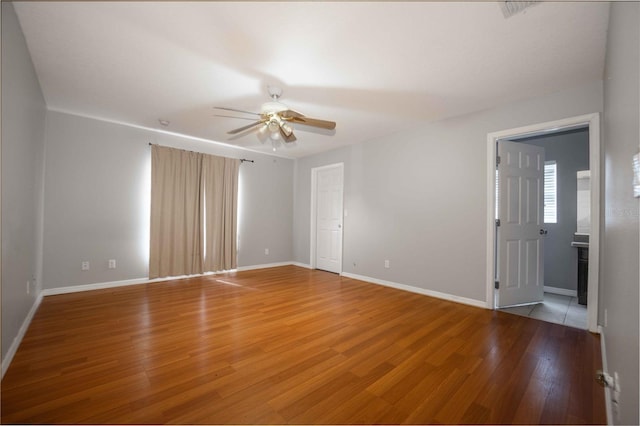 unfurnished room featuring hardwood / wood-style floors and ceiling fan