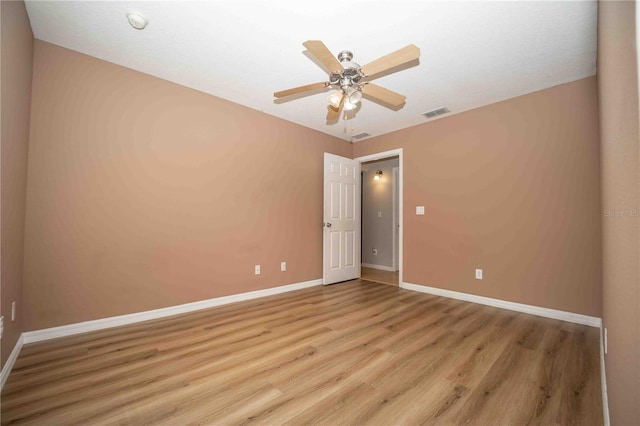 empty room featuring ceiling fan and light wood-type flooring