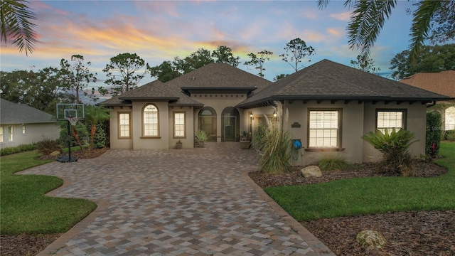 mediterranean / spanish-style house featuring a lawn