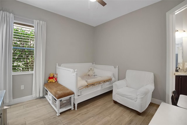 sitting room with light hardwood / wood-style floors, ceiling fan, and sink