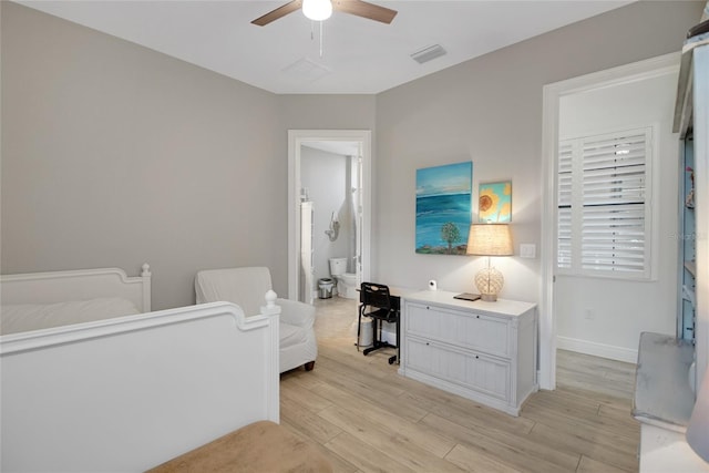 bedroom with ceiling fan, ensuite bathroom, and light hardwood / wood-style flooring