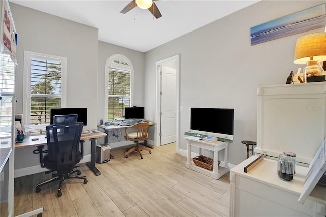 home office featuring light wood-type flooring and ceiling fan