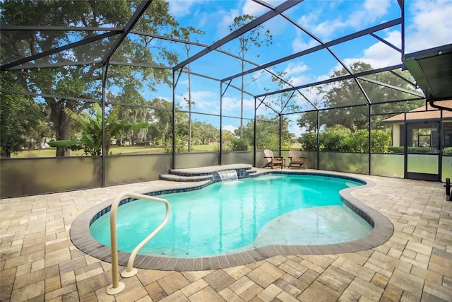 view of swimming pool featuring glass enclosure, pool water feature, and a patio area