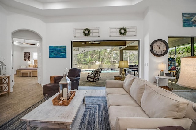 living room with hardwood / wood-style floors and ceiling fan