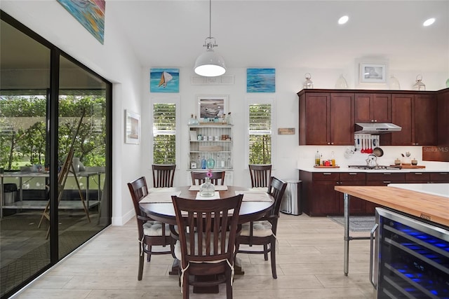 dining space featuring light hardwood / wood-style floors and beverage cooler