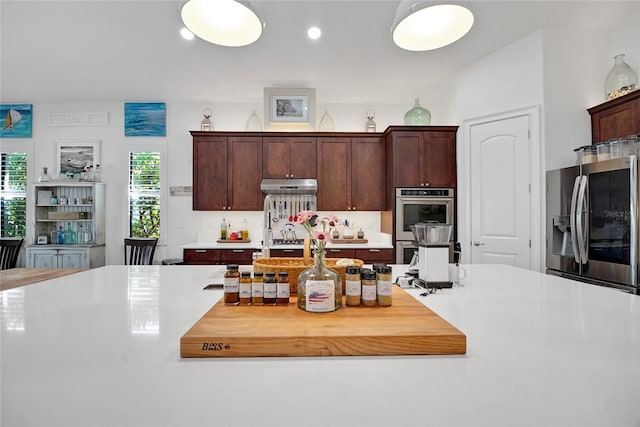 kitchen with appliances with stainless steel finishes and dark brown cabinetry