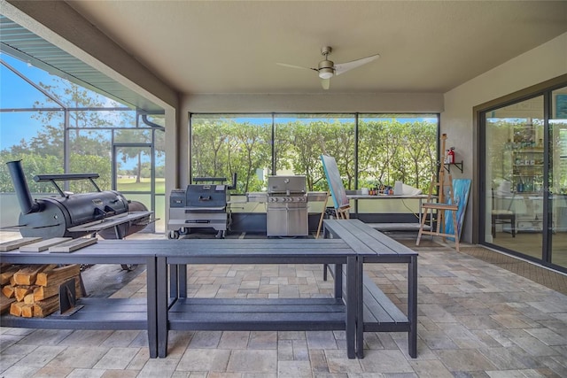 sunroom / solarium featuring ceiling fan