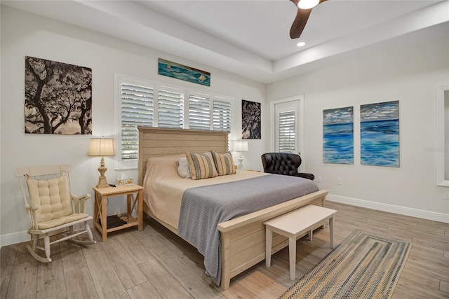 bedroom with multiple windows, light wood-type flooring, and ceiling fan