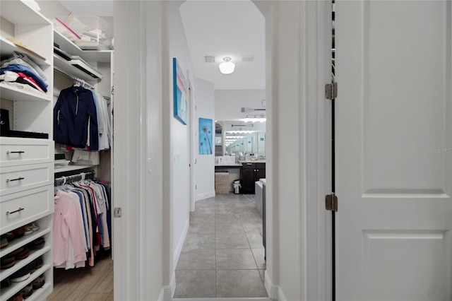 spacious closet featuring light tile patterned flooring