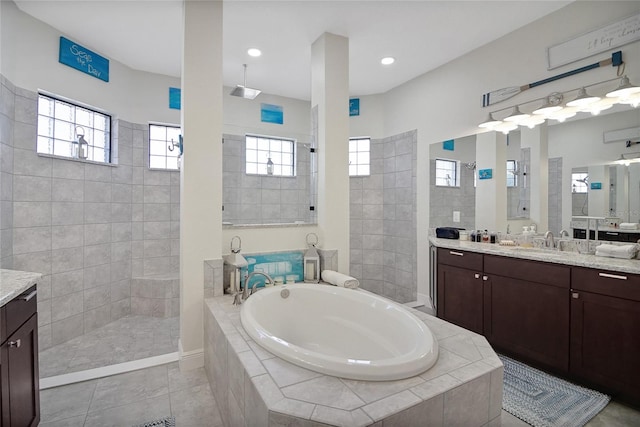 bathroom featuring a wealth of natural light, tile patterned flooring, vanity, and shower with separate bathtub