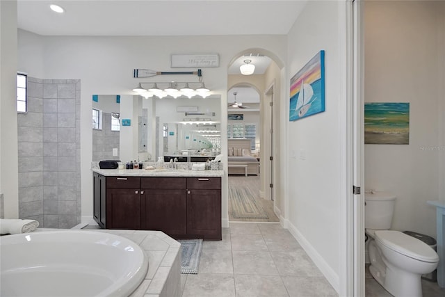 full bathroom featuring vanity, ceiling fan, plus walk in shower, tile patterned flooring, and toilet