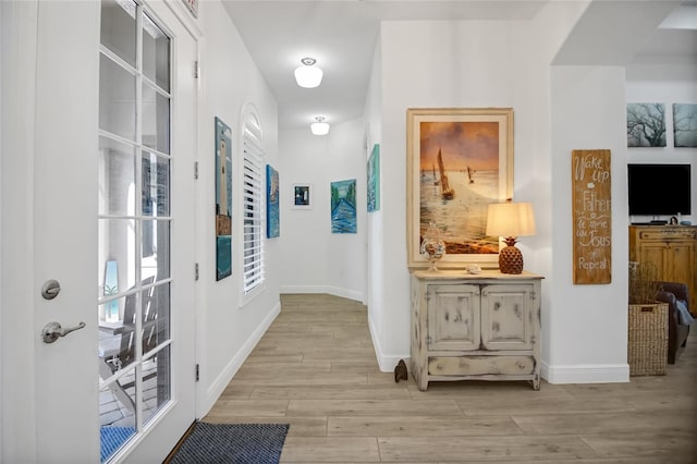 corridor with light hardwood / wood-style floors