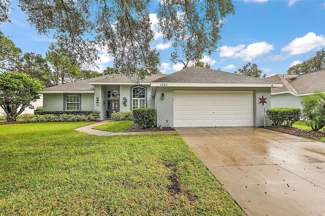 ranch-style home featuring a garage and a front lawn