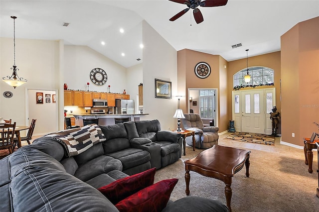 carpeted living room featuring high vaulted ceiling and ceiling fan