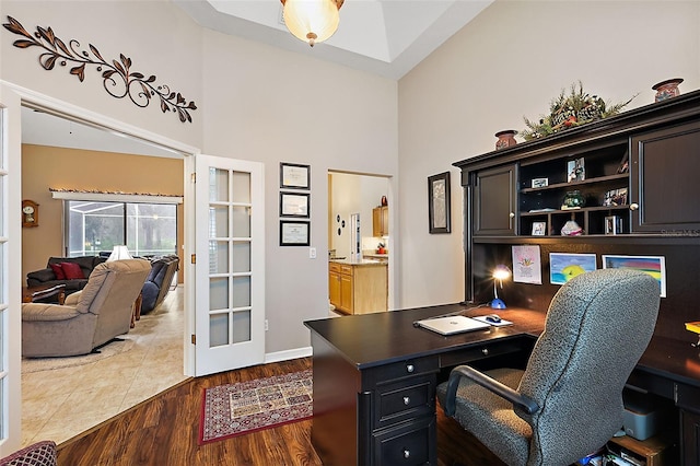 1720 Park Forest Blvd, Mount Dora, FL 32757 - office space featuring a towering ceiling, dark wood-type flooring, built in study area, baseboards, and french doors