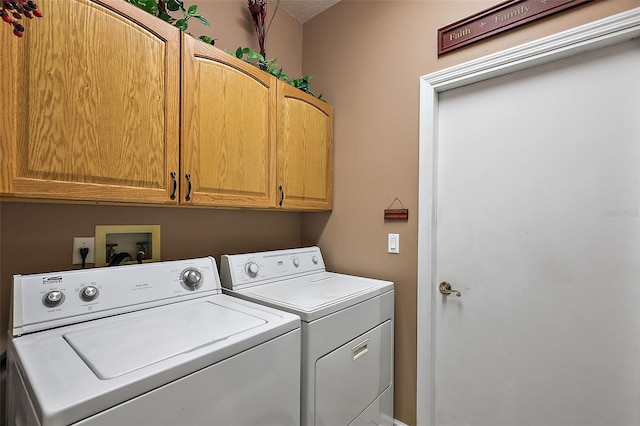 washroom with cabinets and separate washer and dryer