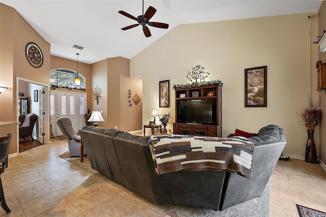 living room featuring ceiling fan, light tile patterned floors, and high vaulted ceiling