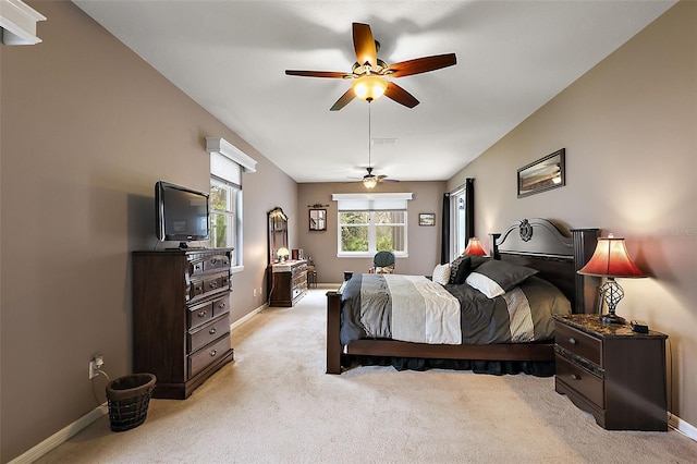 bedroom featuring light colored carpet and ceiling fan