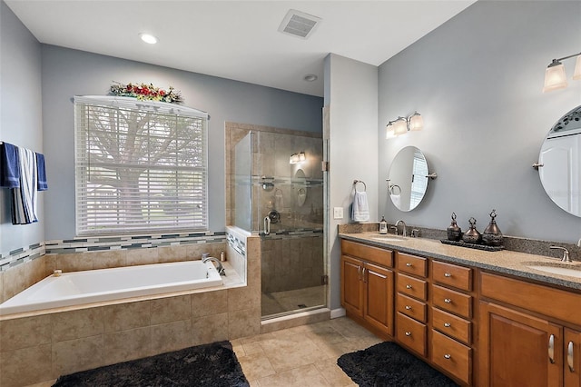 bathroom featuring vanity, tile patterned floors, and separate shower and tub