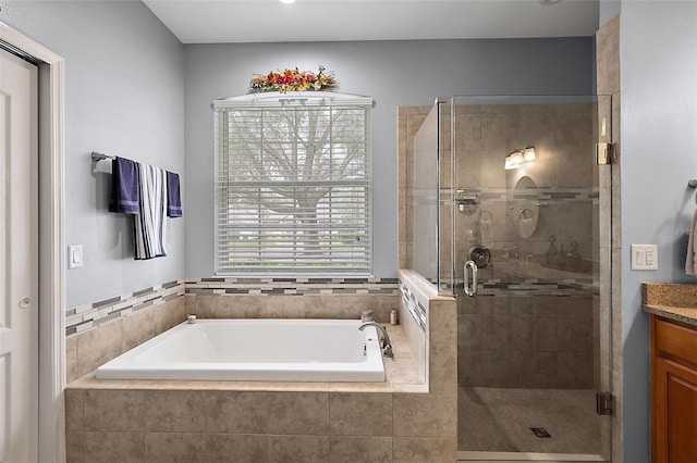 bathroom featuring vanity and independent shower and bath