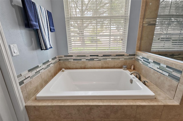 bathroom featuring tiled tub