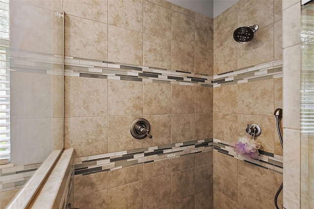 interior details featuring a tile shower