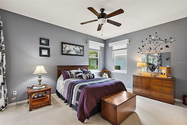 bedroom featuring light carpet and ceiling fan