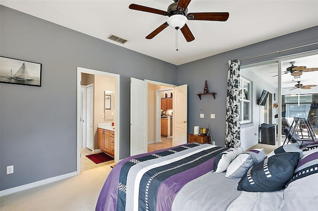 bedroom featuring light carpet, ceiling fan, and connected bathroom