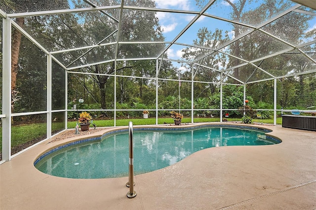 view of pool with glass enclosure and a patio