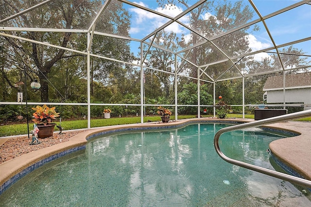 view of swimming pool with glass enclosure and a patio area