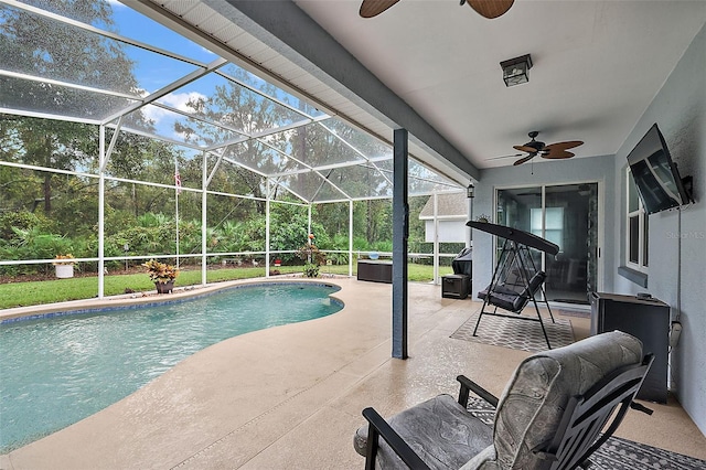 view of swimming pool with a patio area, a lanai, and ceiling fan