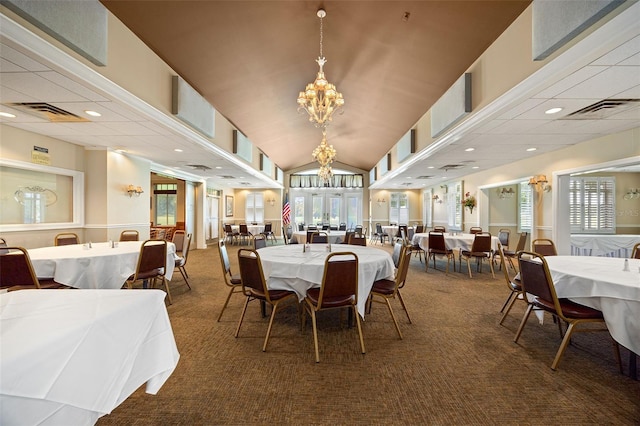 carpeted dining space with vaulted ceiling and a notable chandelier