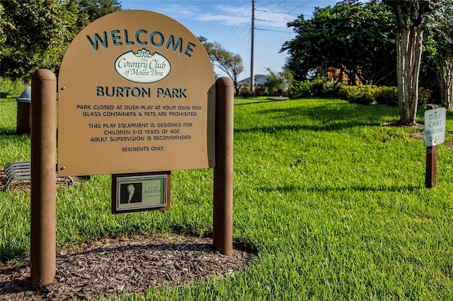 community / neighborhood sign with a lawn