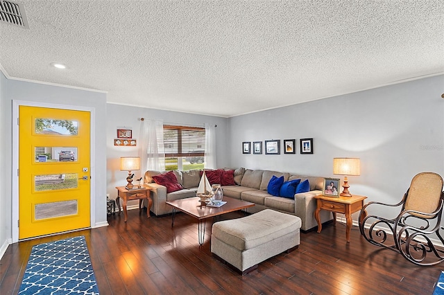 living room with dark wood-type flooring, a textured ceiling, and ornamental molding