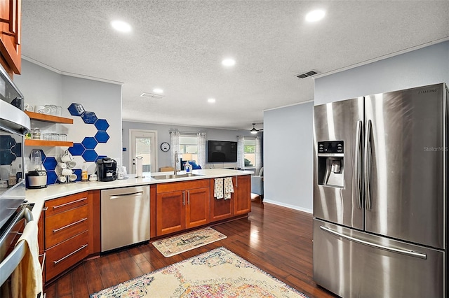 kitchen with a textured ceiling, sink, dark hardwood / wood-style floors, and stainless steel appliances