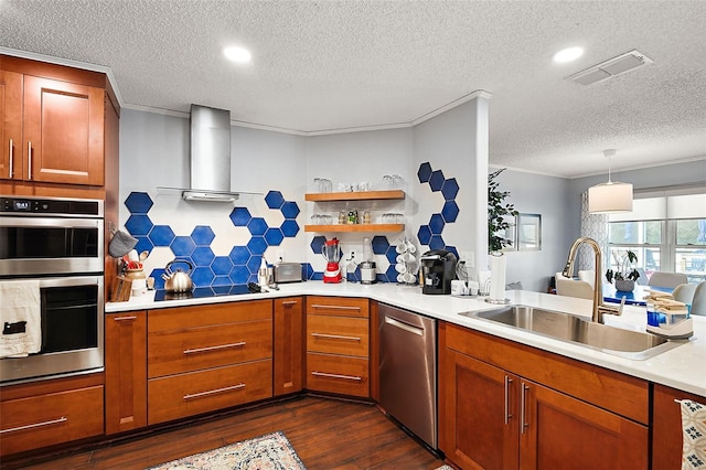 kitchen featuring stainless steel appliances, pendant lighting, sink, dark wood-type flooring, and wall chimney exhaust hood