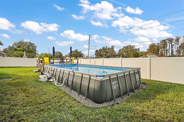 view of swimming pool with a yard