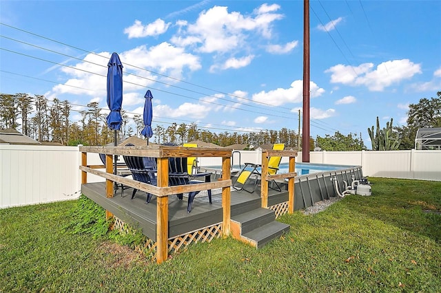 wooden deck with a fenced in pool and a yard