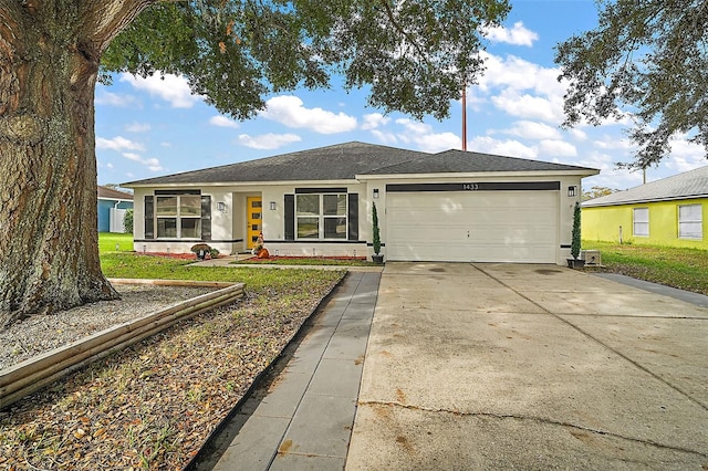 single story home with a garage and a front yard