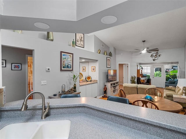 kitchen featuring lofted ceiling, sink, and ceiling fan