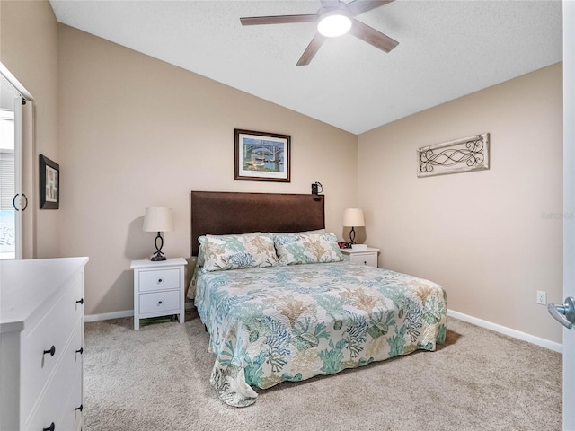 bedroom featuring light colored carpet, lofted ceiling, and ceiling fan