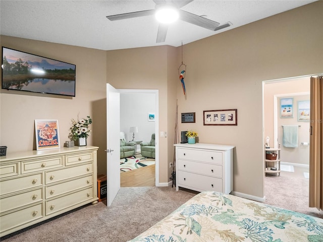 carpeted bedroom featuring ceiling fan and a textured ceiling