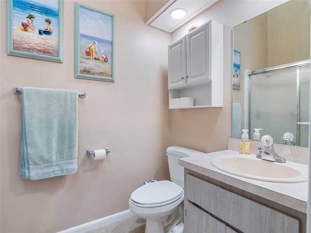 bathroom featuring an enclosed shower, vanity, and toilet