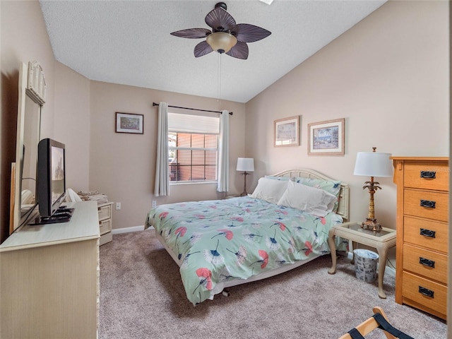 bedroom with ceiling fan, a textured ceiling, vaulted ceiling, and light colored carpet