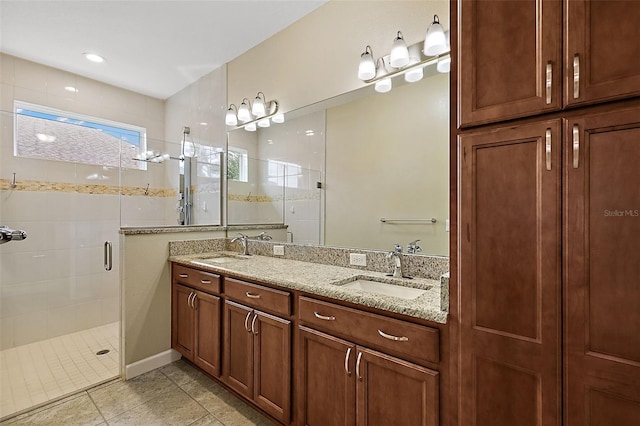 bathroom with tile patterned floors, vanity, and a shower with door