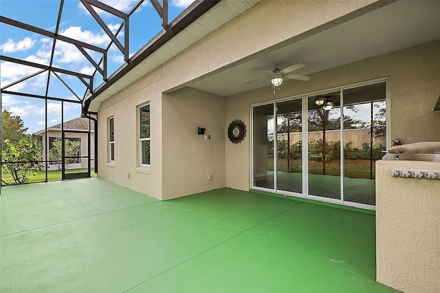 view of patio / terrace featuring ceiling fan and a lanai