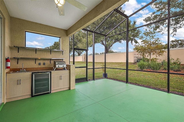 unfurnished sunroom with wet bar, beverage cooler, and ceiling fan